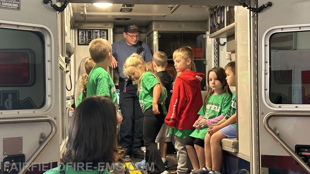 Sitting inside the ambulance and asking questions.
