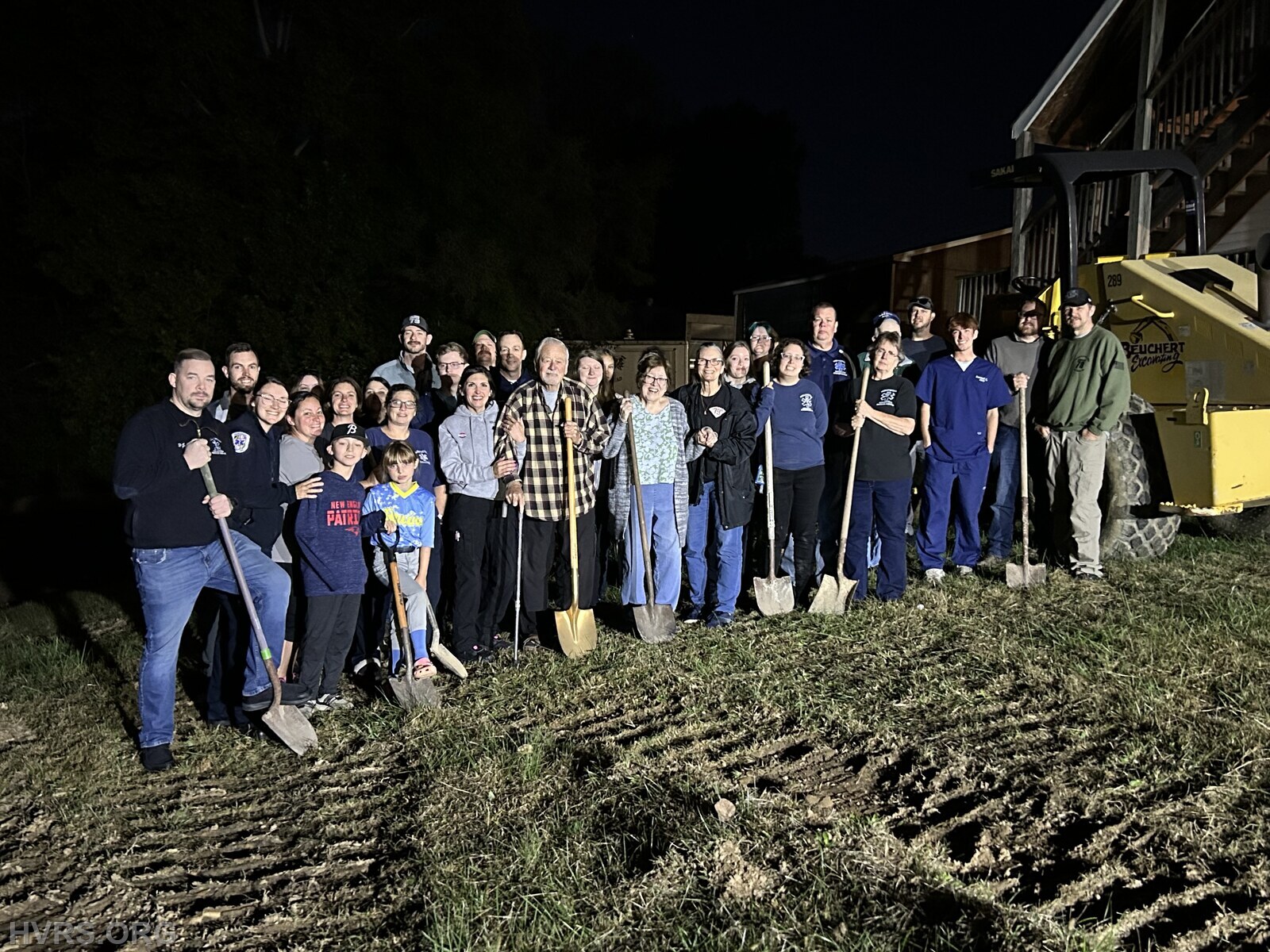 Groundbreaking in the dark. Members attending the regular drill night participated in officially breaking ground.
